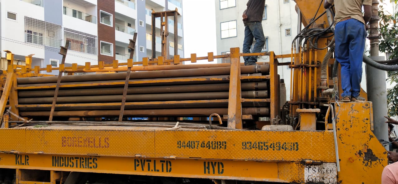 Borewell drilling rig loaded with drill rods at a Hyderabad site